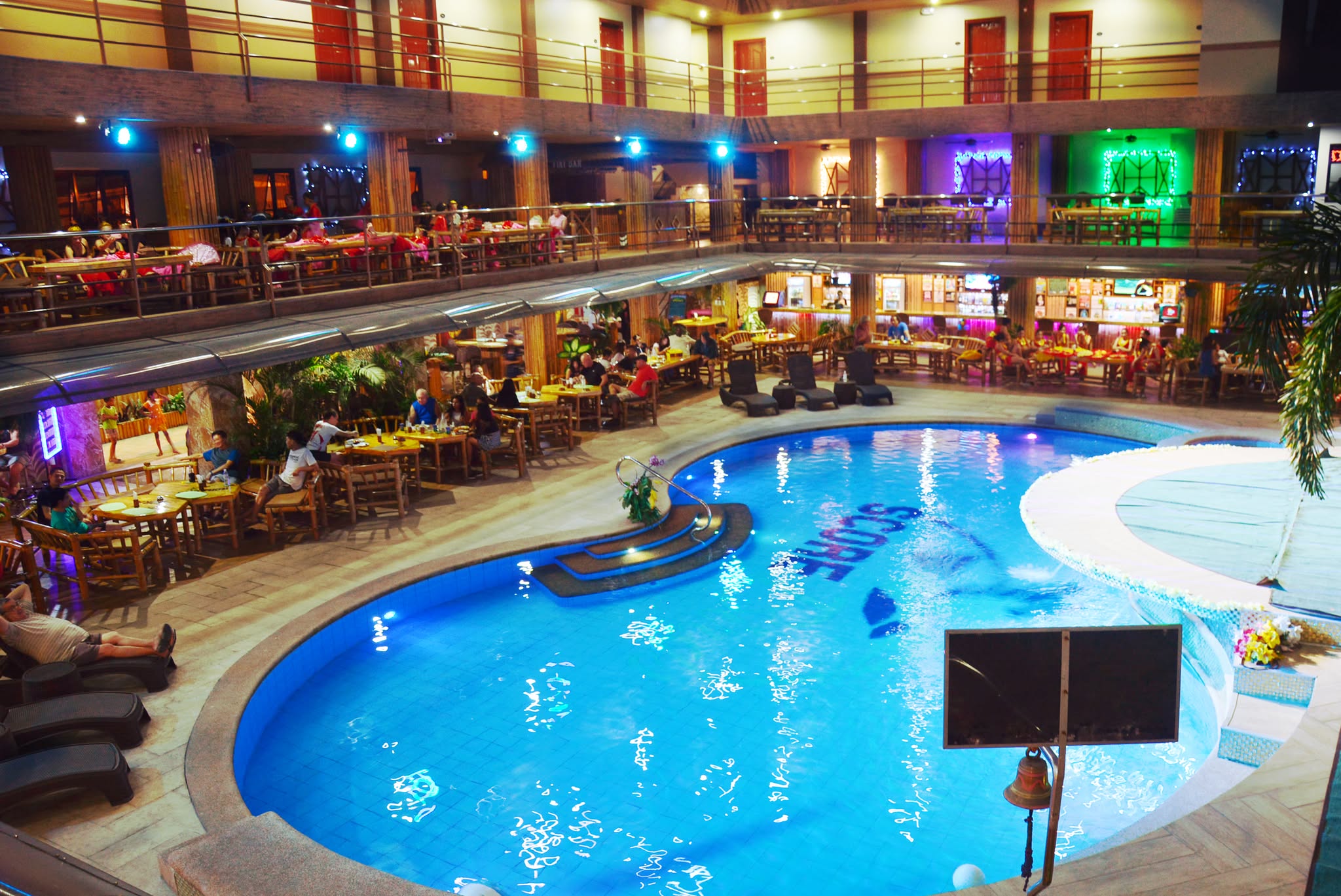 ScoreBirds Hotel pool glowing at night — Angeles City, Philippines